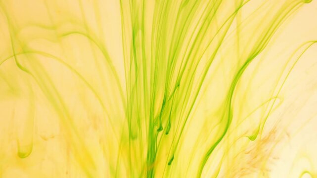 Green ink breaks up in water creating abstract structures, inky background
