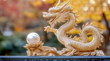Obraz premium Majestic Dragon Sculpture with Pearl Against a Serene Background