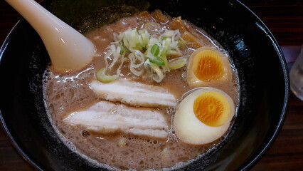 Ramen is a Japanese noodle soup with wheat noodles in a flavorful broth, often topped with meat, eggs, seaweed, and vegetables, blending rich taste and comforting warmth.