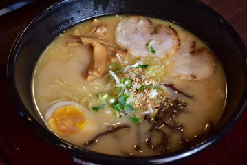 Ramen is a Japanese noodle soup with wheat noodles in a flavorful broth, often topped with meat, eggs, seaweed, and vegetables, blending rich taste and comforting warmth.