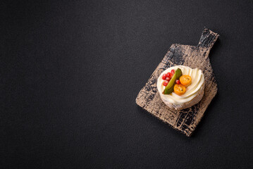 Piece of sweet meringue with citrus, kiwi and pomegranate seeds