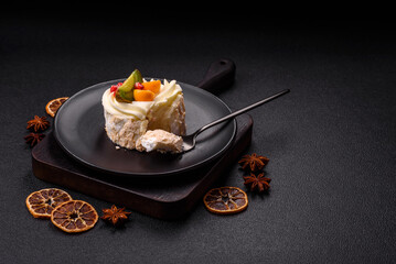 Piece of sweet meringue with citrus, kiwi and pomegranate seeds