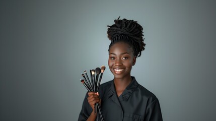 Obraz premium African American smiling Makeup Artist Holding Brushes