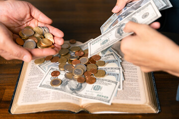 He decided to donate portion of his earnings as tithe, giving money and coins as contribution to...