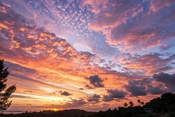 Fototapeta premium A breathtaking sunset sky filled with vibrant hues of orange, pink, and purple, showcasing a dramatic display of clouds at the horizon