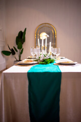 Stylish Christmas table setting. Christmas tree cookie in wineglass, plate with linen