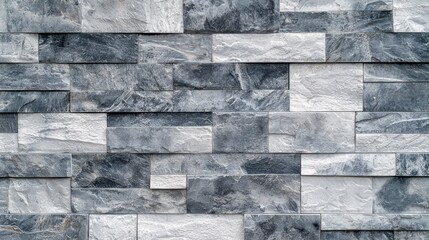 Obraz premium a close up view of a black and white stone wall, which is made up of slate tiles The tiles are arranged in a pattern, creating a unique and eye-catching design Th