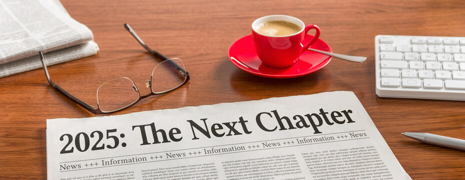 A newspaper on a wooden desk - 2025 the next chapter