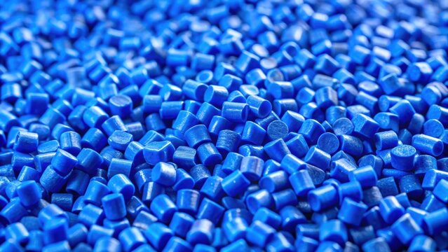 Closeup of blue plastic polypropylene granules with shallow depth of field , masterbatch, polymer, HDPE, PVC, resin