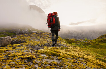Adventurous hiker enthusiastically exploring the stunning and scenic mountain landscape