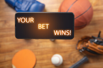 Your Bet Wins! on smartphone screen with a sport equipments.