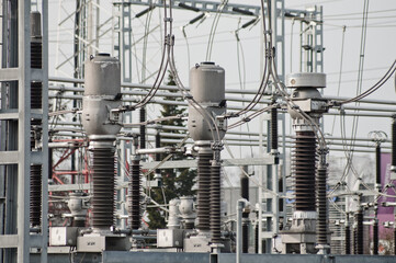 electrical substation and its elements with wires close-up against a gray sky