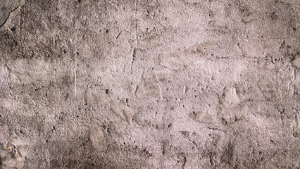 The photo shows an old brown concrete wall