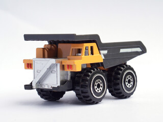 toy mining dump truck isolated on white background. heavy vehicle transporting ore or coal in the quarry.