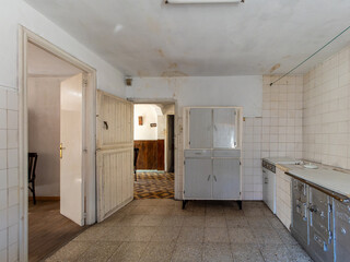 Old damaged kitchen showing neglect and decaying interior