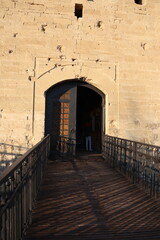 This entrance has a crafted wooden deck and solid stone wall, merging natural elements with design