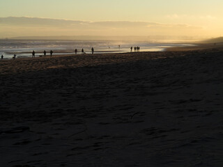 Fototapeta premium Sandy beach and walkers in the distance with back light in Balmedie - Aberdeenshire - Scotland - UK
