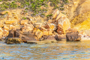 Deserted Haven: Ain Kanassira's Beach Nestled Between Sea and Mountains in Tunisia