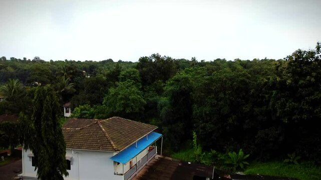 Drone shot of big house of konkan region with green lush vegetations