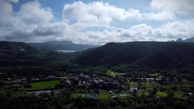 Aerial view of Tiger Point Lonavala with green landscape under clouds and blue sky