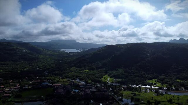 Aerial view of Tiger Point Lonavala with green landscape under clouds and blue sky