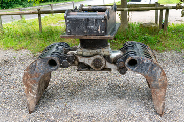 Excavator grab bucket on the ground, ready to be used at a constructionsite.
