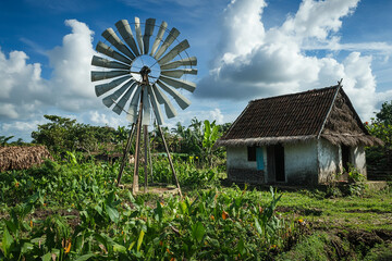 conceptual image windmill fan generate electricity in a small village generated by AI