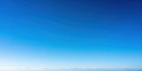 Obraz premium A Clear, Bright, and Vibrant Blue Sky with a Slight Gradient and a Subtle White Cloud Line at the Horizon