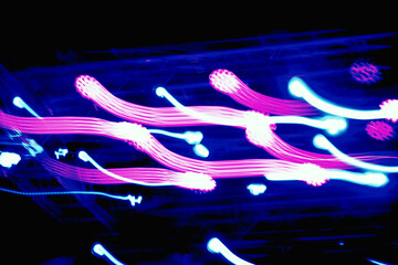 The concept of speed and neon lines. Dynamic movement of light rays and shiny bright technology...