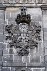 Medieval coat of arms on a medieval stone wall in the Ribeira District, Porto, Portugal