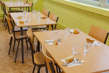 Tables prepared in a school restaurant of a public school. school canteen