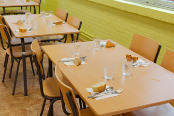 Tables prepared in a school restaurant of a public school. school canteen