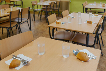 Tables prepared in a school restaurant of a public school. school canteen