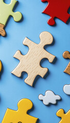 Obraz premium Puzzle pieces in various colors and shapes on blue background create playful and engaging scene. wooden piece stands out among vibrant colors, inviting creativity and imagination
