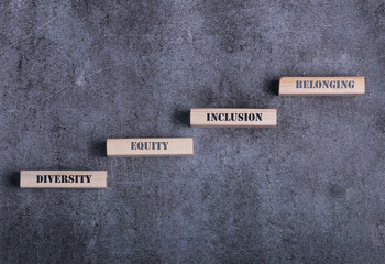Equity, diversity, inclusion and belonging symbol. Wooden blocks with words equity, diversity,...