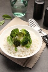Tasty rice with broccoli served on grey table, closeup