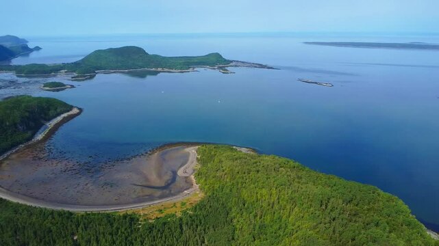 Panoramic drone footage capturing L&rsquo;Anse aux Bouleau-Ouest beach and the picturesque coastal scenery of Bic Regional Park on the St. Lawrence River, Quebec, Canada.