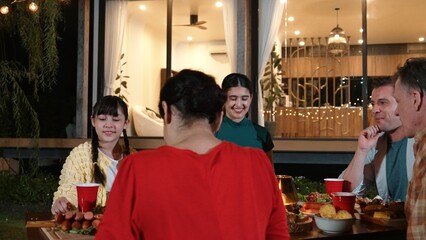 Fototapeta premium Family gather celebrate holiday. Parents, grandparents and girl together to talk and have dinner party food. Outdoor activity for spending time with multigeneration cross generation gap. Divergence.
