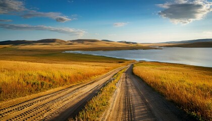 dirty roads in prairie near lake
