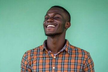 Fototapeta premium A Happy Man Wearing a Plaid Shirt Smiles