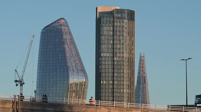 People and an open-top tourist bus crossing Waterloo Bridge in front of One Blackfriars (The Vase / The Boomerang) ITV Tower and The Shard (left to right) November, London, UK