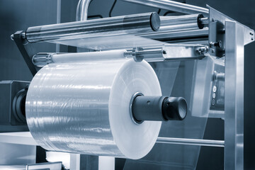 Automatic polyethylene plastic bag production machine with lighting effect. Close-up of the roller...