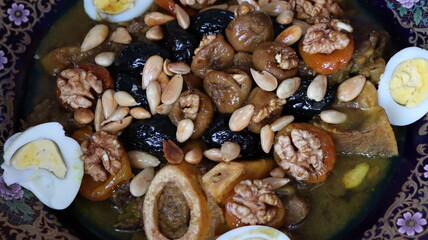 Traditional Moroccan Meat with Prunes, Nuts, and Boiled Eggs in Ornate Peacock Platter – Authentic North African Cuisine for Festive Occasions  
