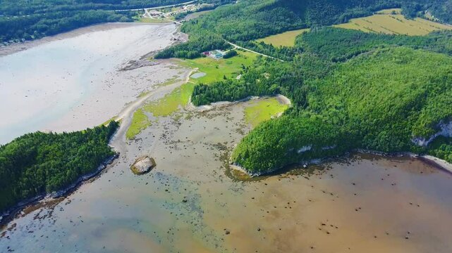 Panoramic aerial view of the lush green shoreline of Bic National Park near &Icirc;le aux Amours and Anse &agrave; Doucet along the St. Lawrence River estuary in Quebec, Canada.