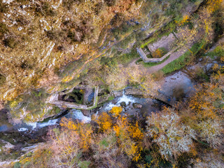 Aerial view of the waterfall at the ruins of Moulin du Saut, an abandoned 18th century water mill, near Gramat on the Alzou river in the Lot region of France