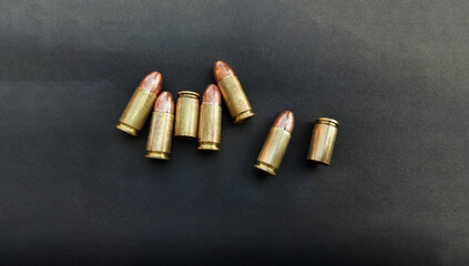 9mm pistol  gun bullets and cartridge cases. Flat lay. Space for text. Concept, dangerous weapon for shooting.    