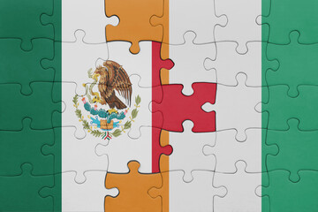 puzzle with the colourful national flag of ivory coast and flag of mexico .