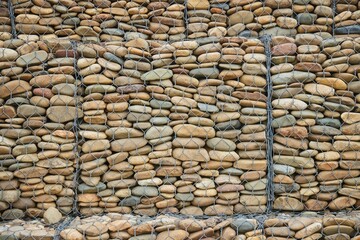 Construction and strengthening of roads from landslides. Stones in a metal mesh, gabions. Technologies in road construction