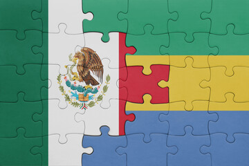 puzzle with the colourful national flag of gabon and flag of mexico .