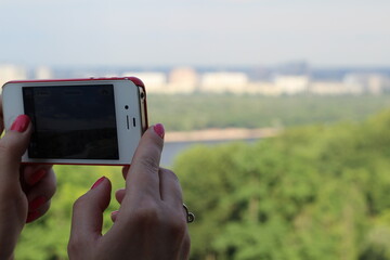 Taking photos with a smartphone. Ukraine. Kyiv. Summer 2013